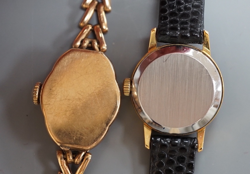 A lady's 9ct gold Accurist manual wind wrist watch, on a 9ct gold bracelet, gross weight 13 grams and a lady's steel and gold plated Omega manual wind wrist watch, on a leather strap.